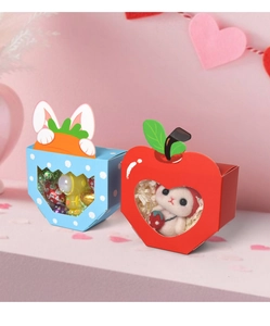 Detail of bunny and apple paper gift boxes with transparent window for holiday candy