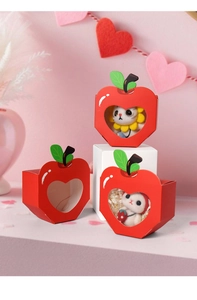 Macro detail of apple-shaped red gift box featuring a heart-shaped clear window display