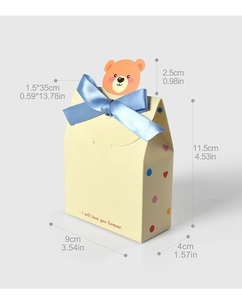 Detailed view of yellow gift box with blue ribbon bow and cute orange bear card