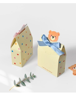 Detailed view of gift boxes featuring cute bear cards, hearts, and satin bows