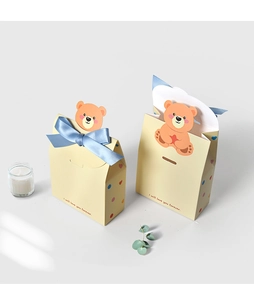 Detail of yellow cartoon bear gift boxes with polka dots and blue silk bow decoration