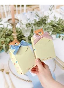 Close-up of cute bear chocolate boxes with colorful ribbons and love you forever text