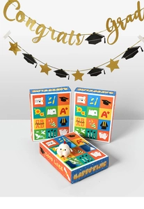 Close-up of graduation punch surprise gift boxes with plush toy and festive decor