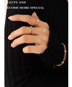 Detail of gold 18K plated open ring set and zircon bracelet on model wrist