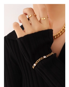Detail of 18K gold plated minimalist open rings and stacked chains jewelry set