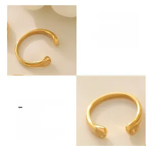 Detail of 18K gold plated surgical steel ring with minimalist curved surface design