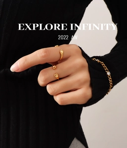 Detail of 18K gold plated minimalist open rings and sparkling zircon chain bracelet