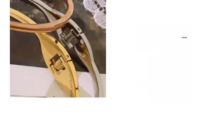Detail of three-tone stainless steel star bracelets showing spring hinge clasp mechanism