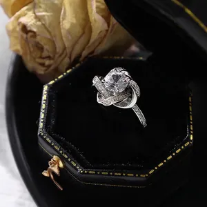 Bague classique en argent avec zircone et design torsadé croisé dans un écrin noir