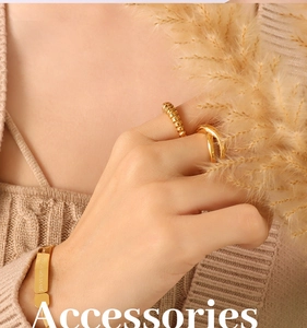 Detailed view of 18K gold plated steel ring and engraved bracelet set on knit fabric