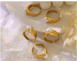 Detail of vintage 18K gold plated titanium ring with a single white pearl accent
