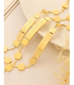 Detailed macro view of 18K gold plated bracelet showing engraved Love without end lettering