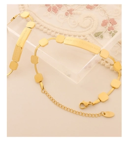 Close-up of gold titanium steel bracelet with engraved Love without end hath no end