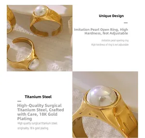 Detail of 18K gold plated titanium ring with a large faux pearl in vintage style