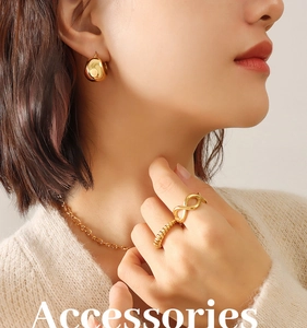 Model wearing gold bead C-shaped earrings and matching minimalist jewelry set
