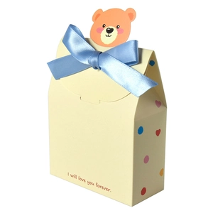 Cream yellow gift box with blue satin bow and cute cartoon bear for Valentine's Day