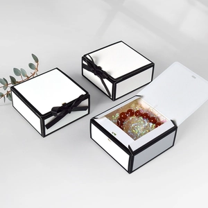 Minimalist square black and white gift boxes with silk ribbons and red bead bracelet