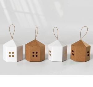 Detail of minimalist house-shaped paper gift boxes with jute handles and cutout windows