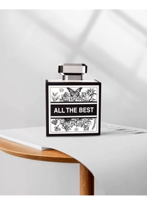Close-up of minimalist perfume box with monochrome botanical illustration and text