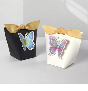 Detail of elegant gift boxes with 3D butterfly accents and gold ribbed ribbon bows