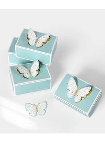 Detail of light blue gift box featuring 3D white butterfly with gold glitter accents