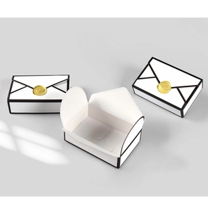 Detail of 2D comic style white envelope gift boxes with gold wax seal and window shadows