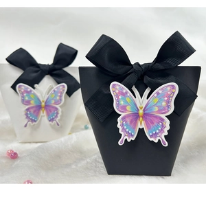 Detail of 3D embossed butterfly gift boxes with premium black ribbed ribbon bows