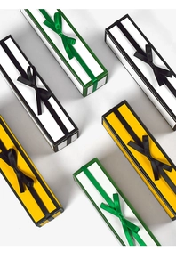 Detailed view of rectangular ribbon gift boxes with elegant bows in yellow and white colors