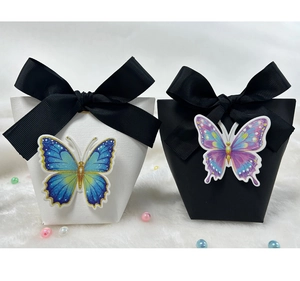 Close-up of elegant black and white gift boxes with 3D butterflies and satin ribbons
