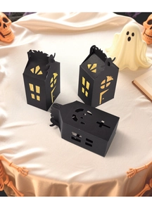 Macro detail of Halloween house gift box with black cut-outs and warm yellow lining