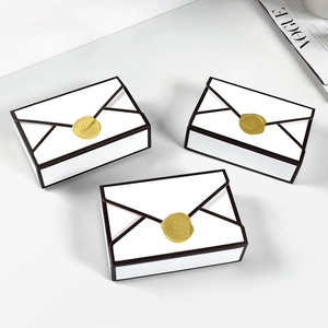Minimalist white envelope gift box with black borders and golden wax seal decoration