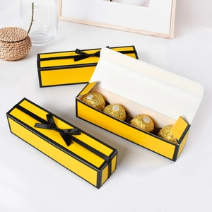 Rectangle yellow gift box with black ribbon bow for chocolate packaging and Valentines Day
