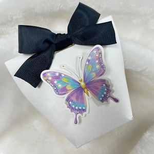 Elegant 3D butterfly gift box with black ribbon bow on white textured paper background