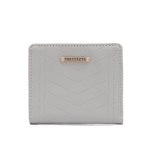 Detail of grey quilted faux leather wallet with gold metal plate and V-shape stitching