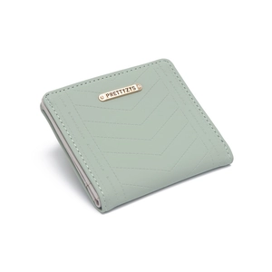 Detail of light green wallet featuring V-shaped stitching and golden metal logo plaque