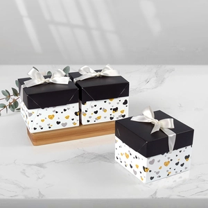 Square gift box set with black lids, white bows and festive heart patterns