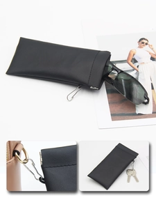 Detail of black leather sunglasses pouch with metal spring closure and carabiner hook