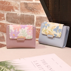 Detail of floral print small PU leather wallets with elegant gold metal buckles for women