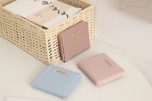 Short quilted leather wallets for women in pink, blue, and dusty rose with metal logos