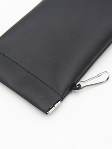 Detail view of black lychee leather sunglasses pouch with metallic spring closure and hook