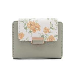 Detail of light green pebbled leather wallet with floral flap and golden clasp