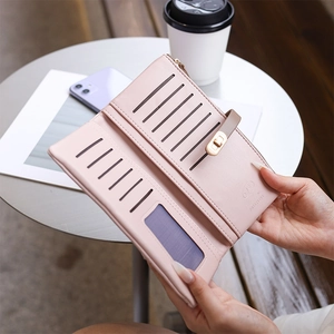 Detail of light pink long wallet interior featuring card slots and a photo window