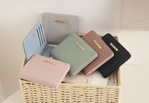 Detailed view of colorful quilted women's wallets with V-pattern and multiple card slots