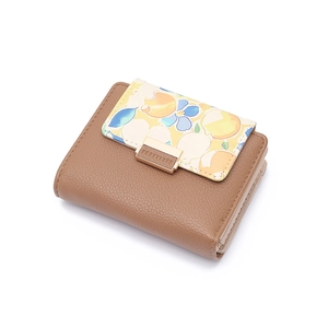 Detail of short tri-fold brown leather wallet with floral flap and gold metal clasp