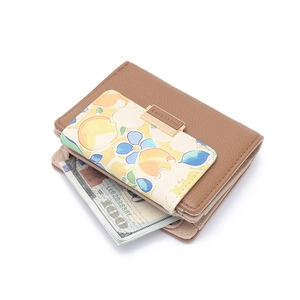 Detail of floral pattern on brown leather short wallet with gold metal buckle