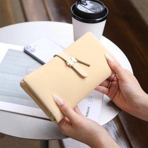 Elegant beige PU leather long wallet for women with gold puzzle-shaped buckle detail