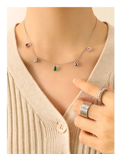Detailed shot of silver bead chain necklace with five colorful teardrop zircon pendants