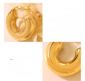 Macro detail of U-shaped earrings crafted in 18K gold plated surgical titanium steel