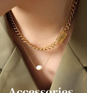 Close-up of double-layer gold chain with freshwater pearl and engraved GIRLS WELOVE pendant