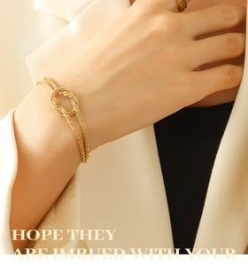Close-up of gold knotted double-chain bracelet with textured Mobius knot detail